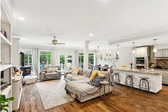 27044 Lucille Dr, Lacombe, LA 70445 - living area featuring dark wood-type flooring, ceiling fan, recessed lighting, ornate columns, and crown molding