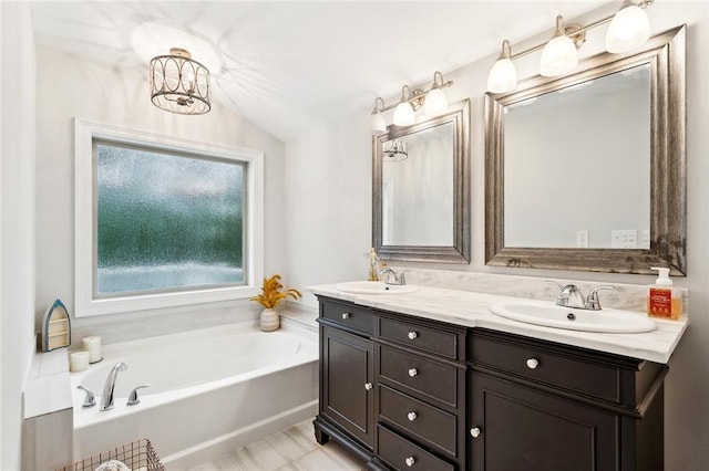 27044 Lucille Dr, Lacombe, LA 70445 - bathroom featuring double vanity, a garden tub, lofted ceiling, and a chandelier