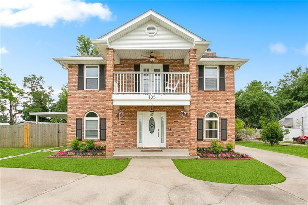 135 Oak St, Hahnville, LA 70057 - view of front of home featuring a balcony, brick siding, ceiling fan, and driveway