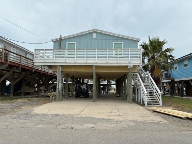 131 Verley Ln, Grand Isle, LA 70358 - beach home featuring a carport, board and batten siding, driveway, and stairway