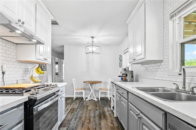 326 Barton Ave, Luling, LA 70070 - kitchen featuring gas range, gray cabinetry, a sink, under cabinet range hood, and decorative backsplash