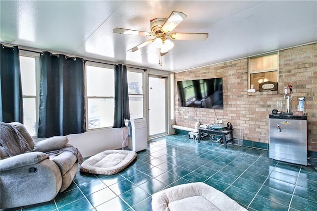 21360 Stire St, Abita Springs, LA 70420 - living area featuring dark tile patterned flooring, a ceiling fan, and brick wall