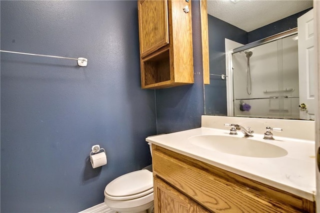 21360 Stire St, Abita Springs, LA 70420 - bathroom featuring a shower with shower door, vanity, toilet, baseboards, and a textured wall
