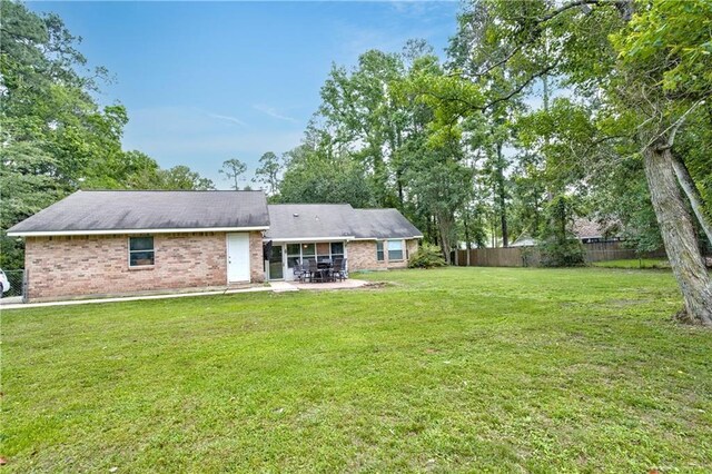 21360 Stire St, Abita Springs, LA 70420 - rear view of house with a patio area and brick siding