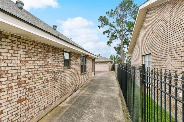 6916 Lake Willow Dr, New Orleans, LA 70126 - view of home's exterior featuring brick siding and a detached garage