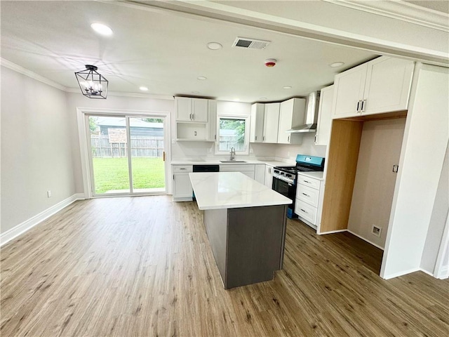 3805 Purdue Dr, Metairie, LA 70003 - kitchen with electric range, a sink, white cabinetry, baseboards, and light wood-type flooring