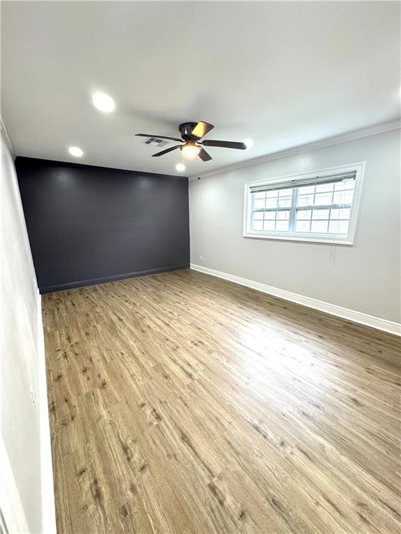 3805 Purdue Dr, Metairie, LA 70003 - empty room featuring ornamental molding, baseboards, recessed lighting, ceiling fan, and wood finished floors