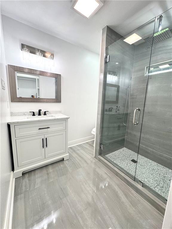 3805 Purdue Dr, Metairie, LA 70003 - full bath featuring vanity, a stall shower, marble finish floors, toilet, and baseboards