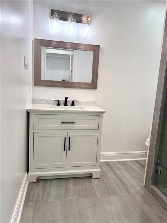 3805 Purdue Dr, Metairie, LA 70003 - bathroom with baseboards, vanity, and a stall shower