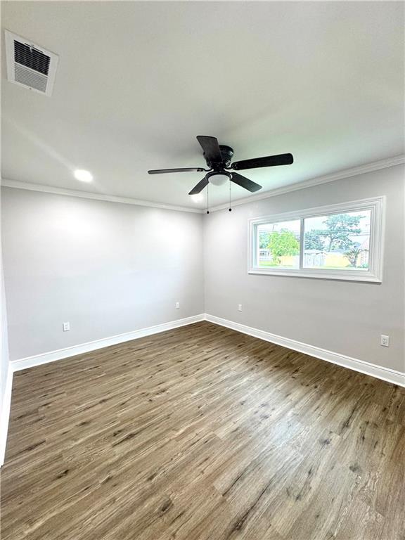 3805 Purdue Dr, Metairie, LA 70003 - empty room featuring ornamental molding, baseboards, wood finished floors, and a ceiling fan