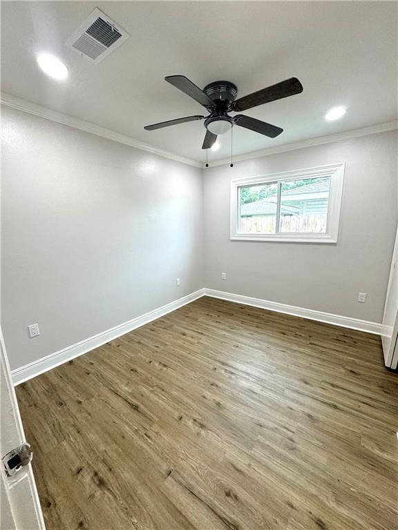 3805 Purdue Dr, Metairie, LA 70003 - spare room featuring crown molding, wood finished floors, a ceiling fan, and baseboards