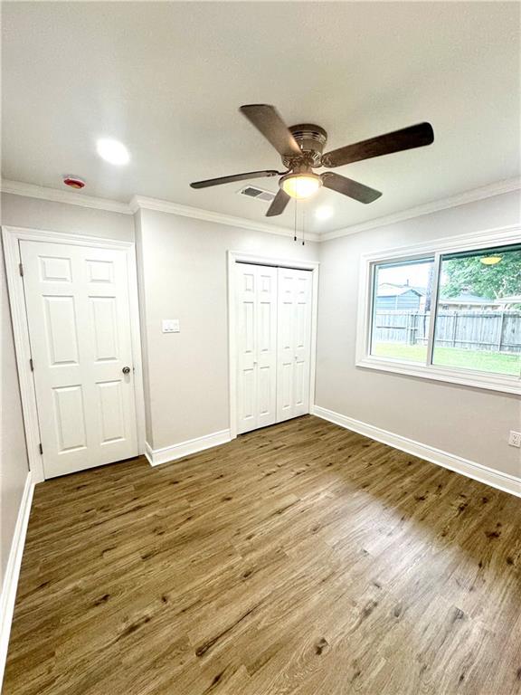 3805 Purdue Dr, Metairie, LA 70003 - unfurnished bedroom featuring ornamental molding, wood finished floors, baseboards, a closet, and a ceiling fan