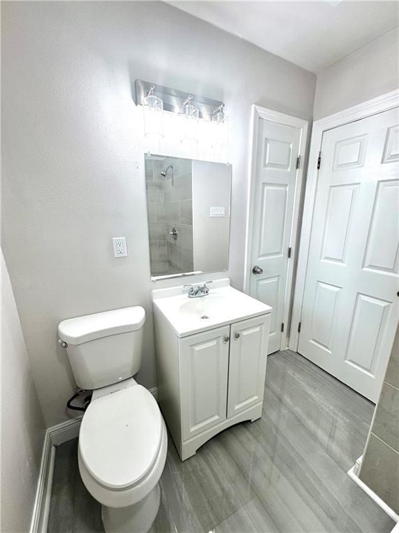 3805 Purdue Dr, Metairie, LA 70003 - full bath with vanity, toilet, a tile shower, and wood finished floors