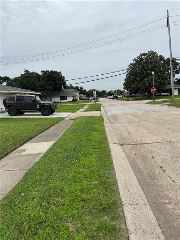 3805 Purdue Dr, Metairie, LA 70003 - view of concrete street featuring sidewalks and traffic signs