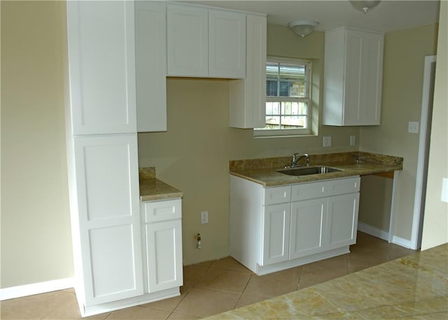 6 Marywood Ct, New Orleans, LA 70128 - kitchen featuring a sink, light tile patterned flooring, white cabinets, and baseboards