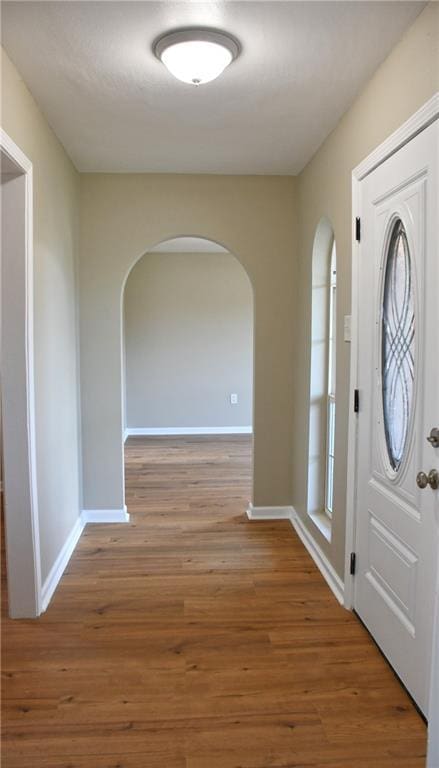 6 Marywood Ct, New Orleans, LA 70128 - foyer featuring arched walkways, baseboards, and wood finished floors