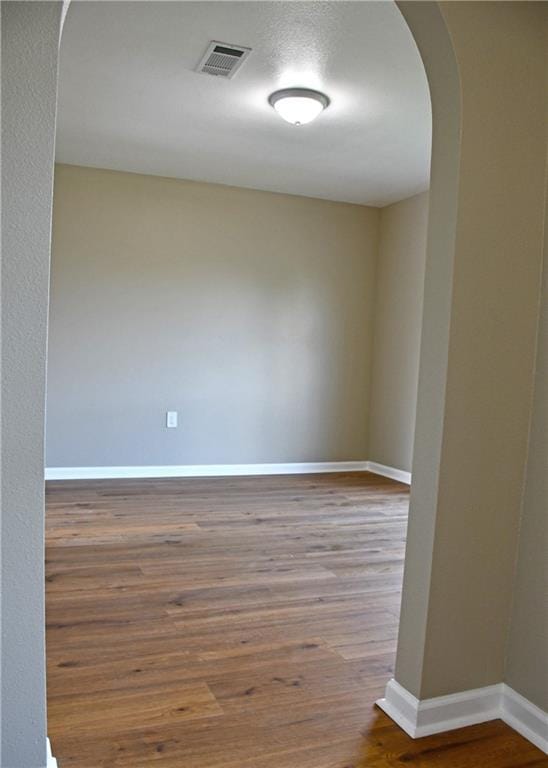 6 Marywood Ct, New Orleans, LA 70128 - empty room with arched walkways, wood finished floors, and baseboards