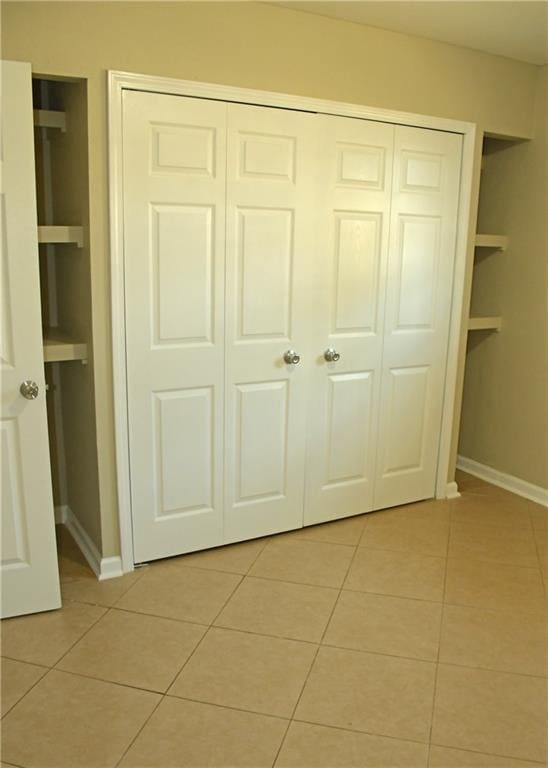 6 Marywood Ct, New Orleans, LA 70128 - unfurnished bedroom with light tile patterned floors, baseboards, and a closet