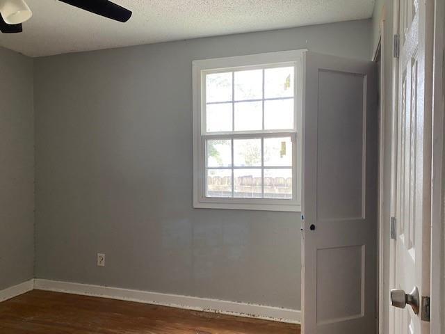 7 Labarre Pl, Jefferson, LA 70121 - empty room featuring dark wood finished floors, baseboards, and a ceiling fan