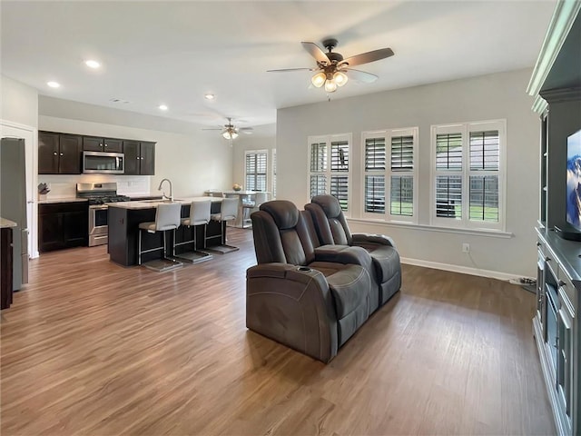75616 Sylvia Dr, Covington, LA 70435 - living area with wood finished floors, ceiling fan, recessed lighting, and baseboards