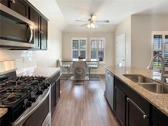 75616 Sylvia Dr, Covington, LA 70435 - kitchen with appliances with stainless steel finishes, a sink, ceiling fan, wood finished floors, and plenty of natural light