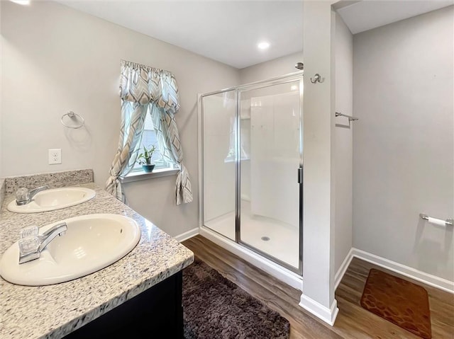 75616 Sylvia Dr, Covington, LA 70435 - full bath with wood finished floors, a shower stall, double vanity, baseboards, and recessed lighting