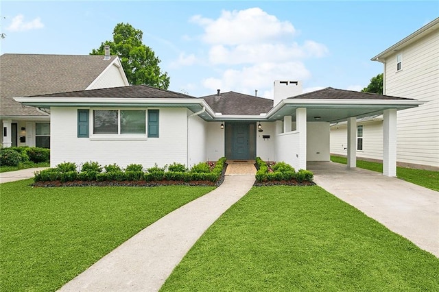 4912 Ithaca St, Metairie, LA 70006 - view of front facade with driveway, a chimney, a front lawn, a carport, and a shingled roof