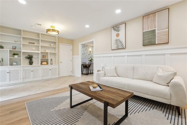 4912 Ithaca St, Metairie, LA 70006 - living area featuring recessed lighting, a decorative wall, wainscoting, and light wood-type flooring