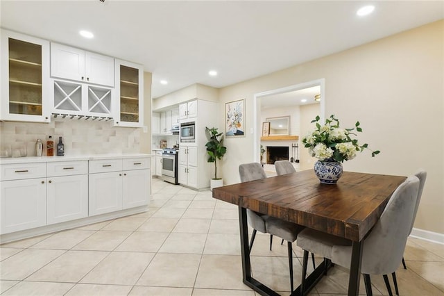 4912 Ithaca St, Metairie, LA 70006 - dining area with light tile patterned flooring, recessed lighting, and baseboards