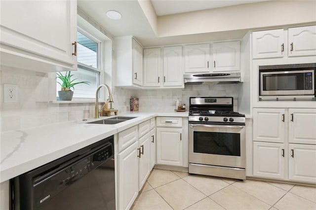 4912 Ithaca St, Metairie, LA 70006 - kitchen with appliances with stainless steel finishes, a sink, under cabinet range hood, white cabinets, and light tile patterned floors