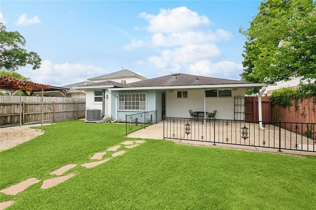 4912 Ithaca St, Metairie, LA 70006 - back of property with a patio area, central air condition unit, stucco siding, and a shingled roof
