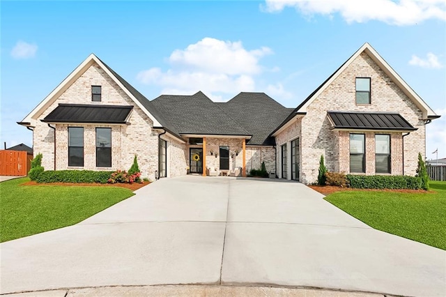 1600 Heatherwood Dr, Harvey, LA 70058 - view of front facade with concrete driveway, brick siding, and a standing seam roof