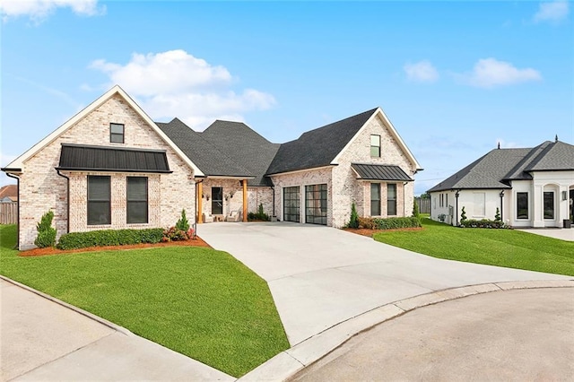 1600 Heatherwood Dr, Harvey, LA 70058 - view of front of property with brick siding, driveway, a front lawn, a standing seam roof, and an attached garage