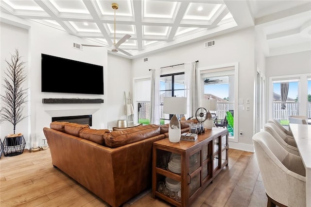 1600 Heatherwood Dr, Harvey, LA 70058 - living area with a ceiling fan, a glass covered fireplace, wood-type flooring, beam ceiling, and coffered ceiling