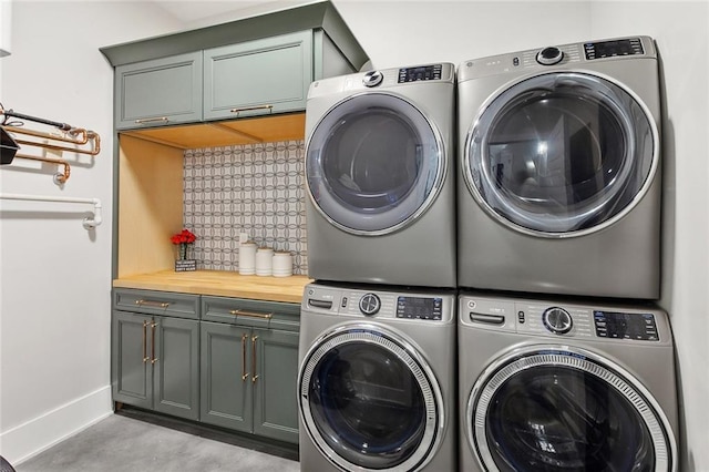1600 Heatherwood Dr, Harvey, LA 70058 - washroom featuring cabinet space, stacked washer / drying machine, baseboards, and washer and dryer