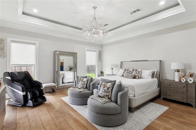 1600 Heatherwood Dr, Harvey, LA 70058 - bedroom featuring a raised ceiling, a chandelier, multiple windows, light wood finished floors, and crown molding