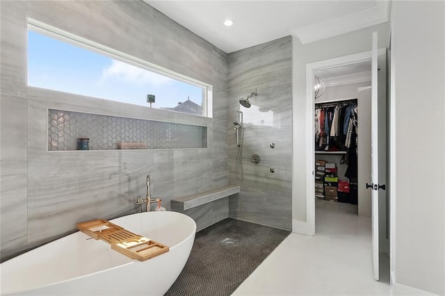 1600 Heatherwood Dr, Harvey, LA 70058 - bathroom with a freestanding bath, walk in shower, a spacious closet, concrete floors, and recessed lighting