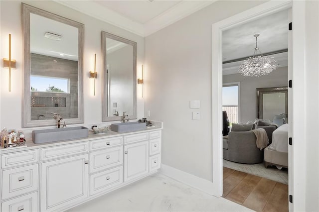 1600 Heatherwood Dr, Harvey, LA 70058 - bathroom with ensuite bathroom, double vanity, healthy amount of natural light, a chandelier, and ornamental molding
