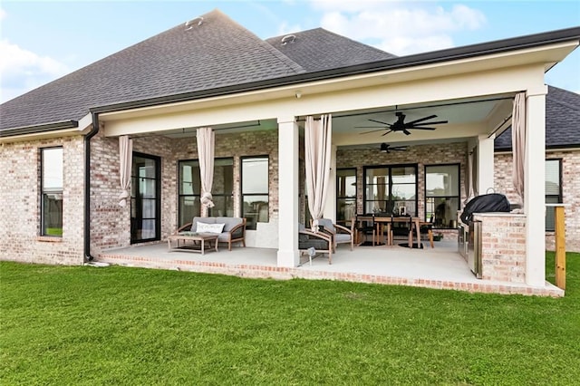 1600 Heatherwood Dr, Harvey, LA 70058 - back of property featuring a shingled roof, a ceiling fan, a patio area, an outdoor hangout area, and a lawn