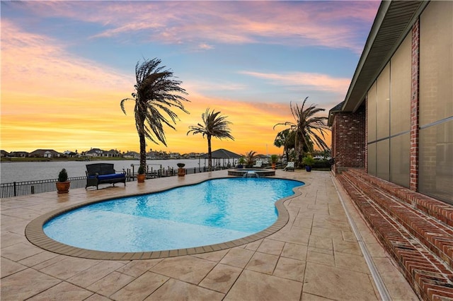 1125 Lakeshore Blvd, Slidell, LA 70461 - pool at dusk with a patio area and a pool with connected hot tub