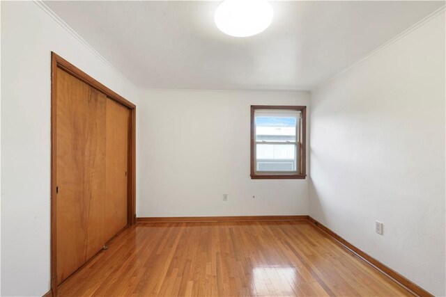 7356 Cameo St, New Orleans, LA 70124 - unfurnished bedroom featuring a closet, light wood-style flooring, baseboards, and ornamental molding