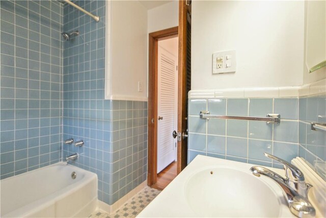 7356 Cameo St, New Orleans, LA 70124 - full bath with tile walls, shower / bath combination, a sink, and wainscoting