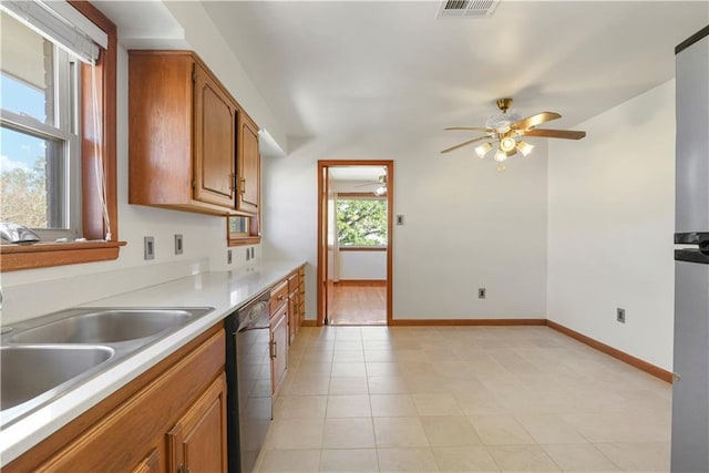 7356 Cameo St, New Orleans, LA 70124 - kitchen with dishwasher, a ceiling fan, brown cabinetry, light countertops, and baseboards