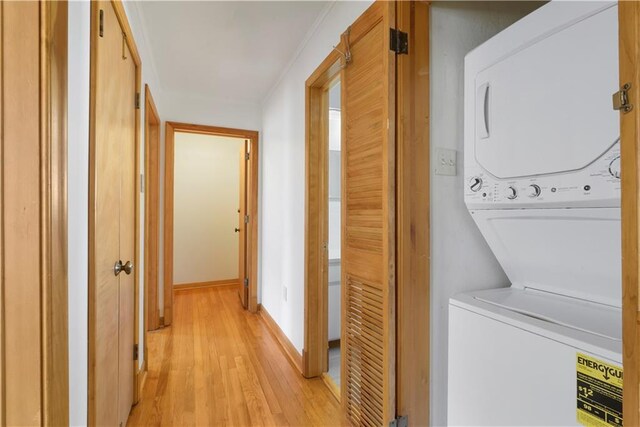 7356 Cameo St, New Orleans, LA 70124 - washroom with estacked washer and dryer, light wood-type flooring, and baseboards