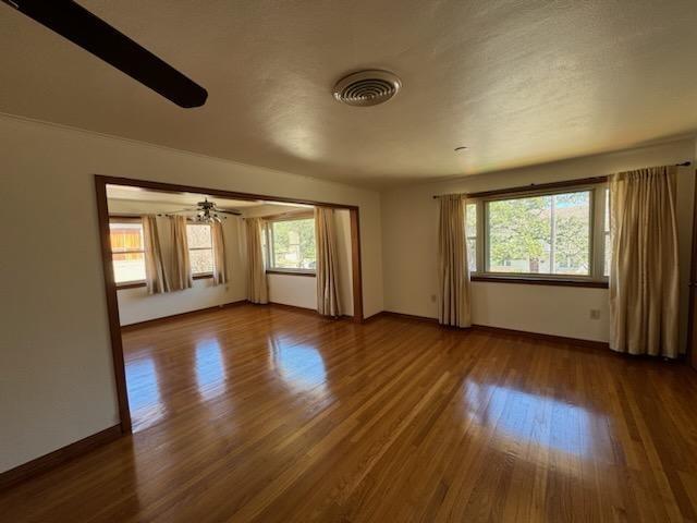 7356 Cameo St, New Orleans, LA 70124 - empty room featuring healthy amount of natural light, wood finished floors, and baseboards