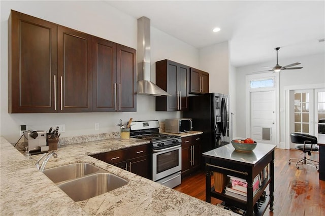 149 Millaudon St, New Orleans, LA 70118 - kitchen with stainless steel appliances, wall chimney exhaust hood, a sink, light stone countertops, and dark wood finished floors