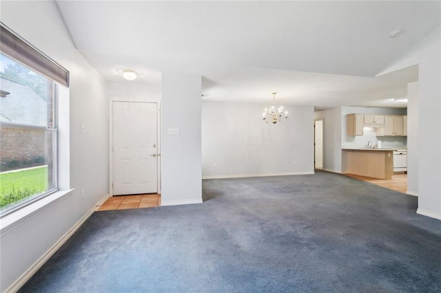 768 Wilkinson St, Mandeville, LA 70448 - unfurnished living room with a chandelier, plenty of natural light, light colored carpet, and baseboards