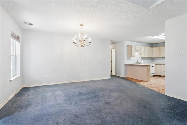 768 Wilkinson St, Mandeville, LA 70448 - unfurnished living room featuring light carpet, a chandelier, baseboards, a textured ceiling, and a sink