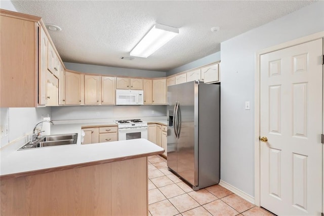 768 Wilkinson St, Mandeville, LA 70448 - kitchen with white appliances, a sink, a peninsula, light brown cabinets, and a textured ceiling