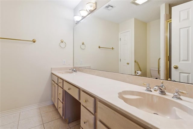 768 Wilkinson St, Mandeville, LA 70448 - bathroom with double vanity, tile patterned flooring, toilet, and baseboards